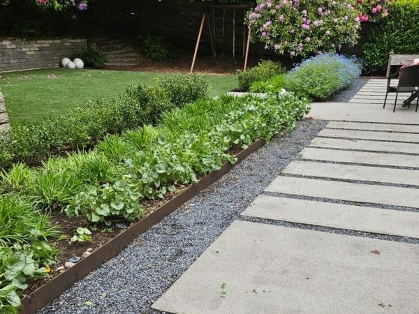 Olympic stepping stones with gravel and native planting